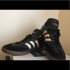 pair of black Adidas low-top sneakers